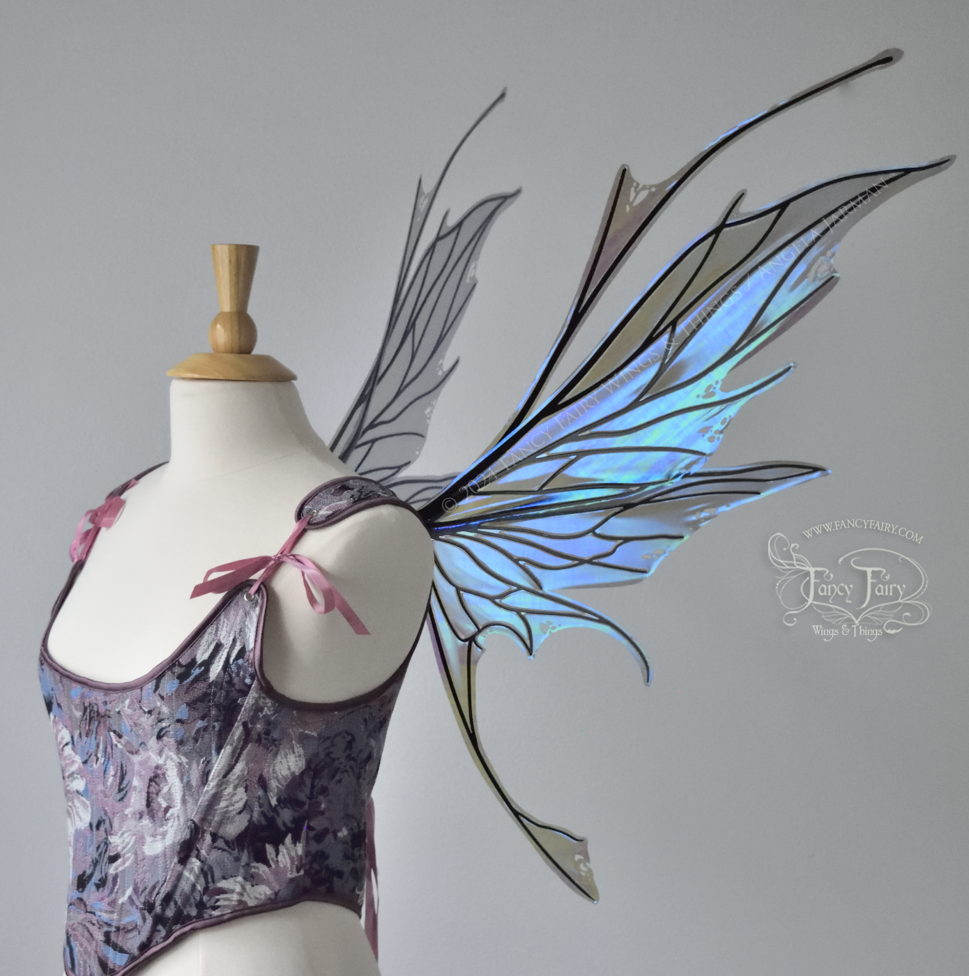 Large spikey iridescent purple & blue fairy wings with black veins and antennae, worn on a dress form, right side view