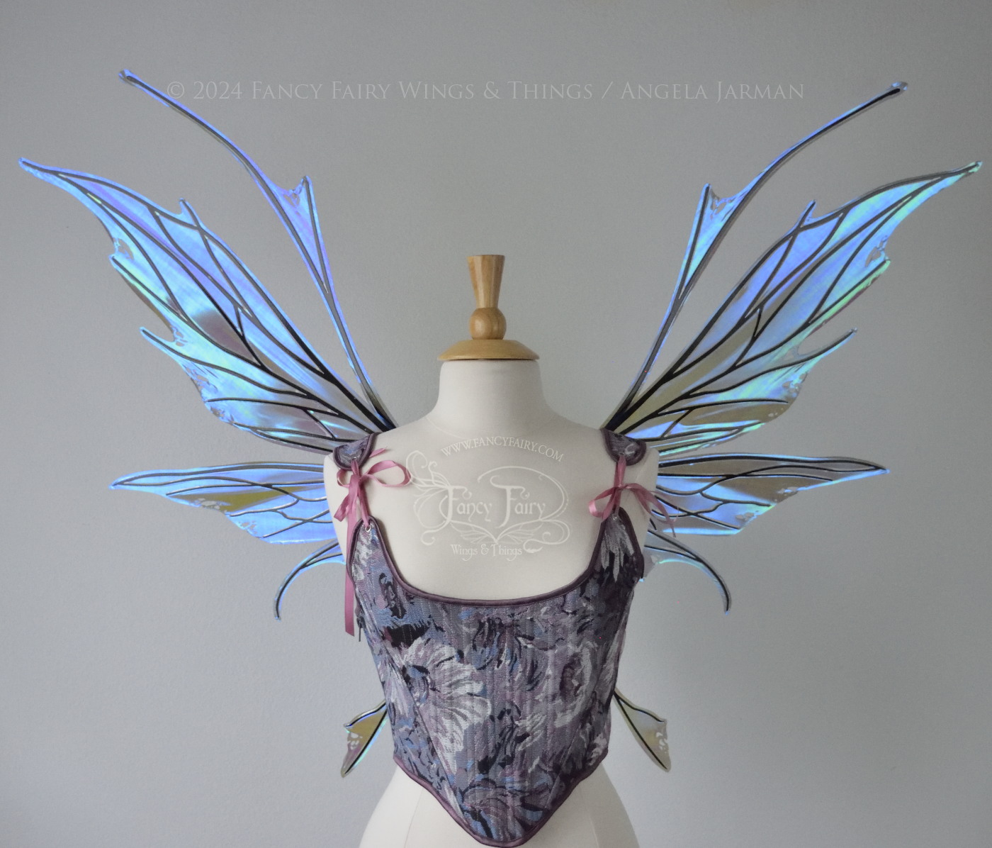 Large spikey iridescent purple & blue fairy wings with black veins and antennae, worn on a dress form, front view