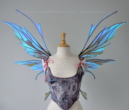 Large spikey iridescent purple & blue fairy wings with black veins and antennae, worn on a dress form, front view