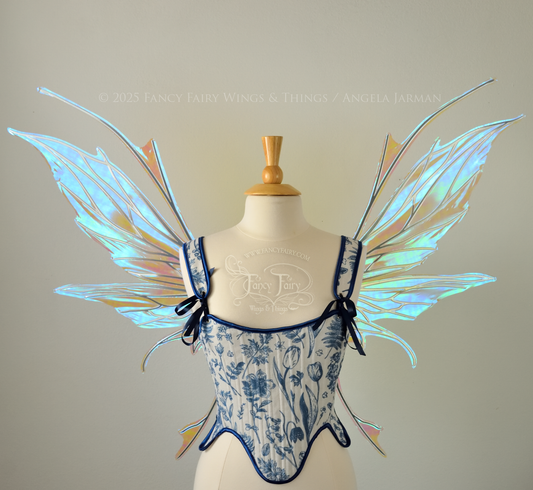Large blue / green  iridescent fairy wings with silver veins featuring antennae along the top and a spikey profile, worn on a dress form, front view