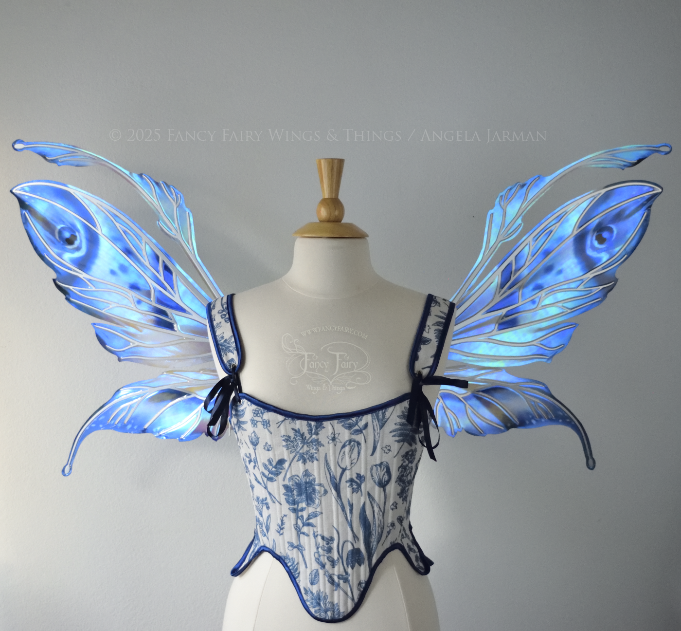 Large blue painted iridescent fairy wings with antennae, silver veins, worn on a dress form, front view