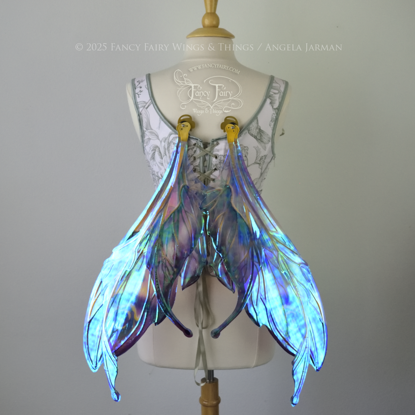 Large mauve, plum and blue iridescent fairy wings with antennae, gold veins, worn on a dress form, back view, in resting position