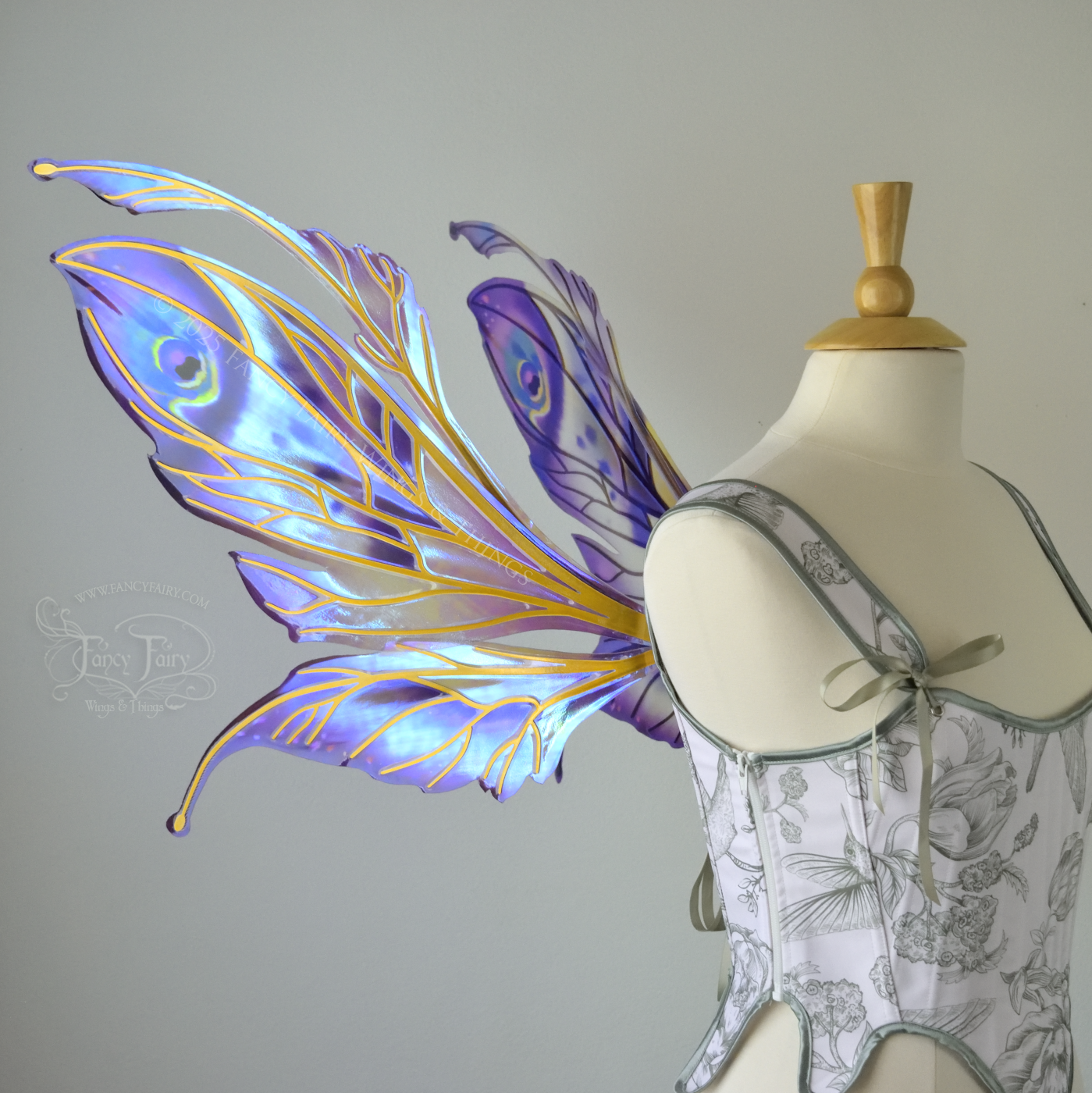 Large mauve, plum and blue iridescent fairy wings with antennae, gold veins, worn on a dress form, left side view