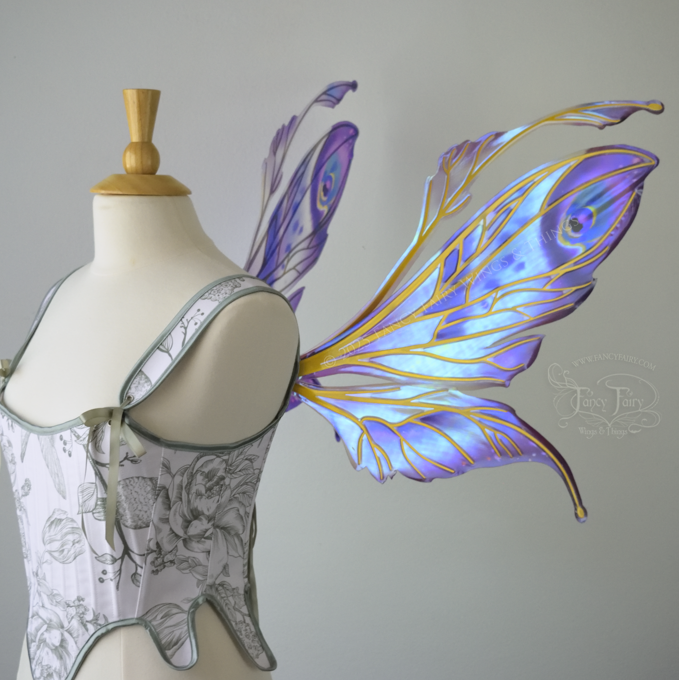 Large mauve, plum and blue iridescent fairy wings with antennae, gold veins, worn on a dress form, right side view