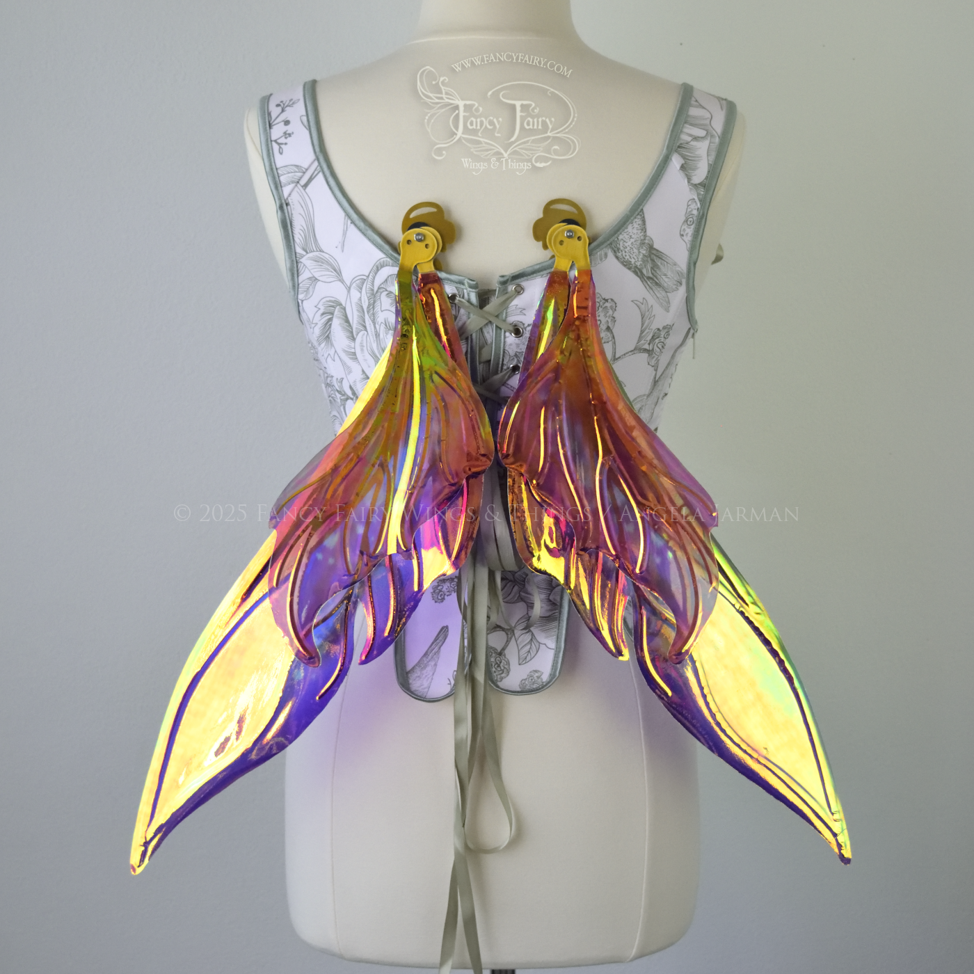 Iridescent elongated purple & fuchsia fairy wings with touches of blue and gold veins, back view, in resting position