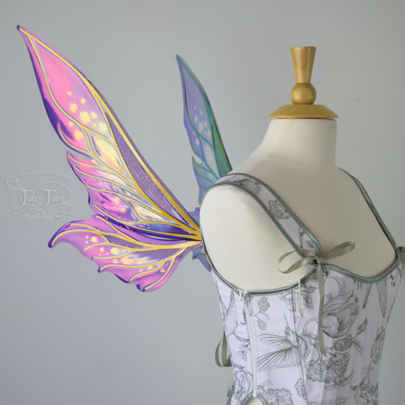Iridescent elongated purple & fuchsia fairy wings with touches of blue and gold veins, left side view 