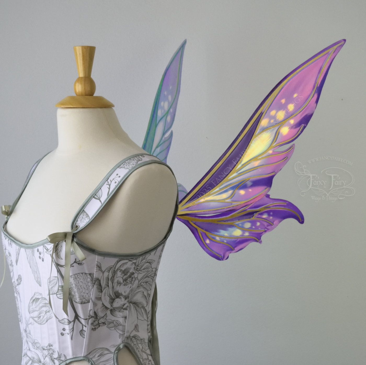 Iridescent elongated purple & fuchsia fairy wings with touches of blue and gold veins, right side view 