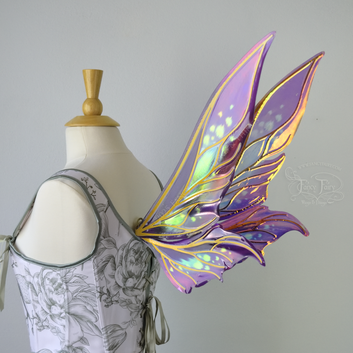 Iridescent elongated purple & fuchsia fairy wings with touches of blue and gold veins, right 3/4 back side view 