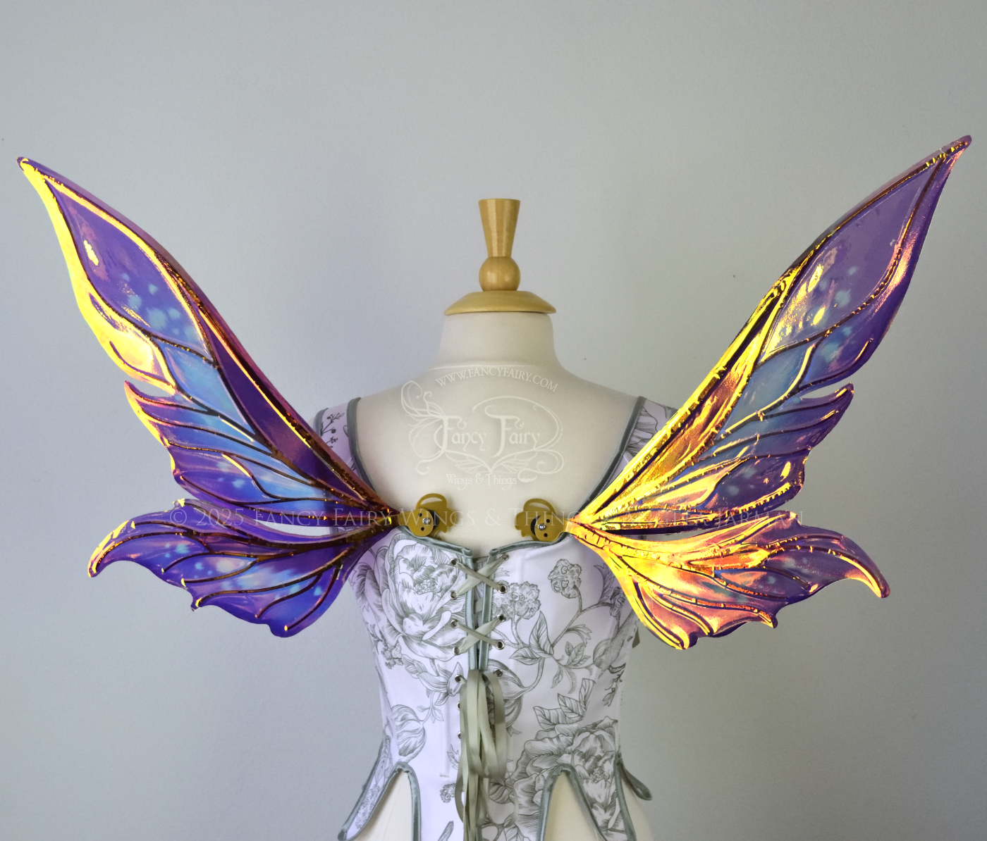 Iridescent elongated purple & fuchsia fairy wings with touches of blue and gold veins, back view 