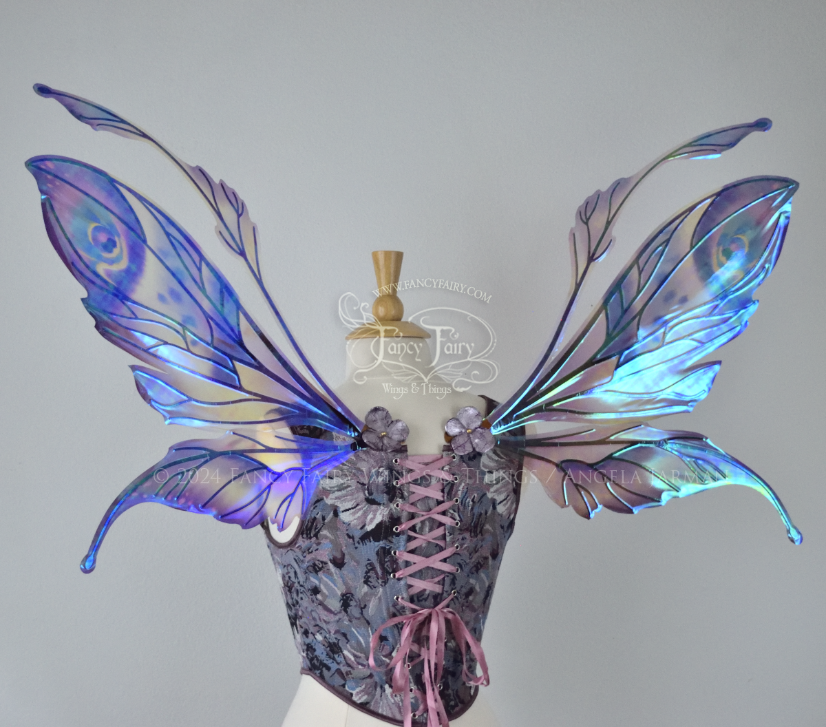 Large mauve, plum and blue iridescent fairy wings with antennae, copper veins, worn with a purple bodice on a dress form, back view