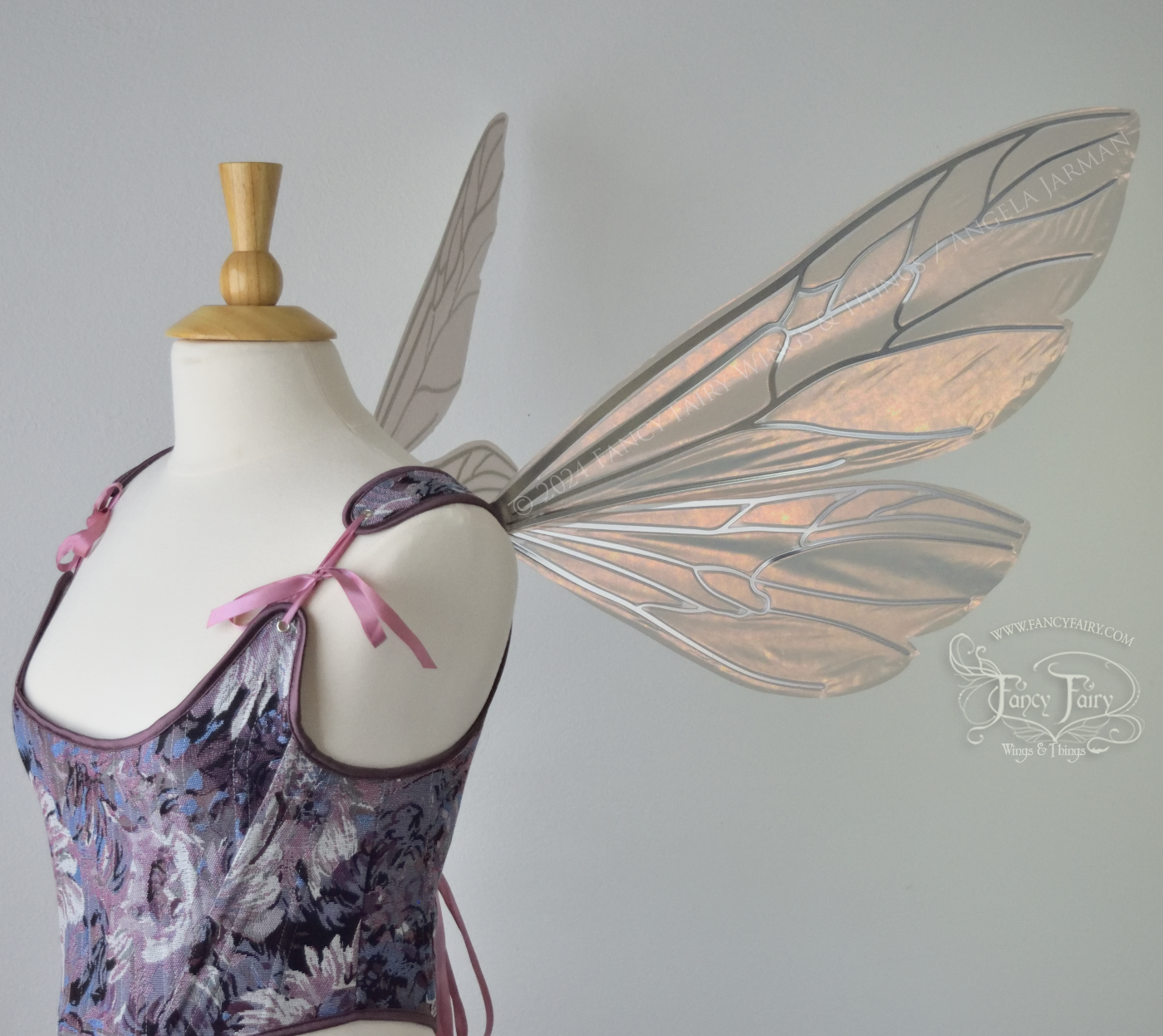 Wasp-shaped fairy wings in iridescent rose gold with silver veins, worn on a dress form, right side view