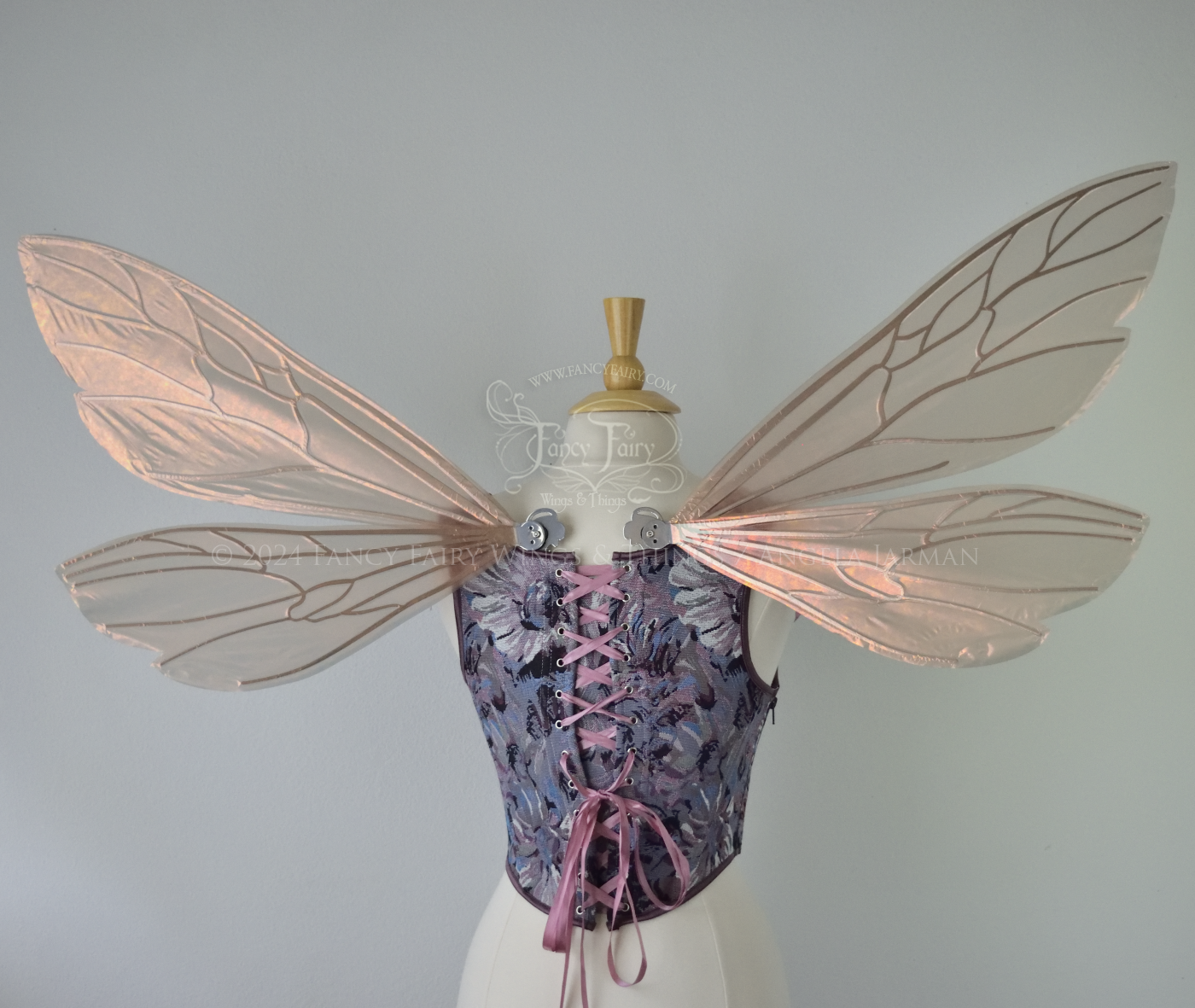 Wasp-shaped fairy wings in iridescent rose gold with silver veins, worn on a dress form, back view