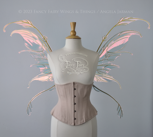 Front view of an ivory dress form wearing an underbust corset & 'Fauna' pinkish iridescent fairy wings with gold veining
