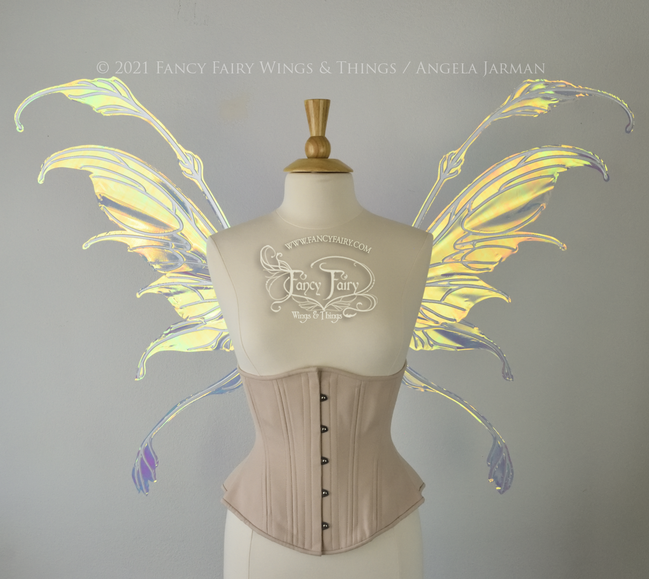 Front view of a dress form wearing an underbust corset & 'Fauna' transparent iridescent fairy wings with downward curved tips, antennae & wispy 'tails', with white veining