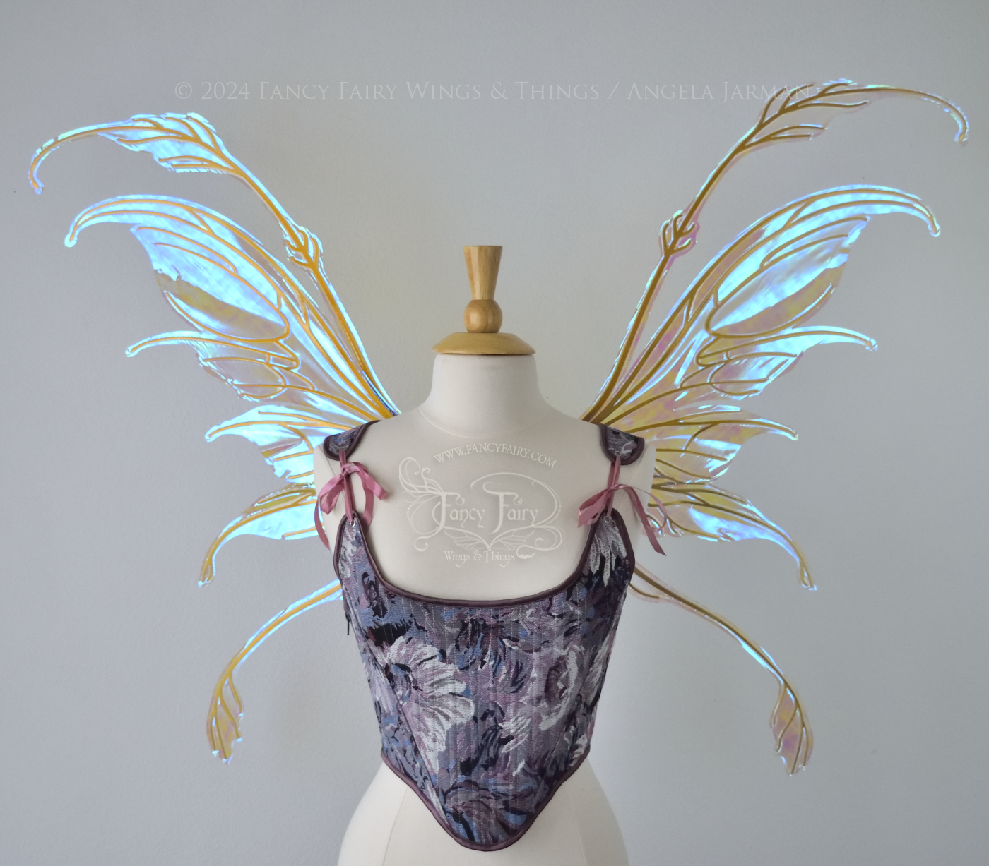 Large blue / green transparent iridescent fairy wings with downward curved tips, antennae & appendages, gold veins, worn on a dress form, front view