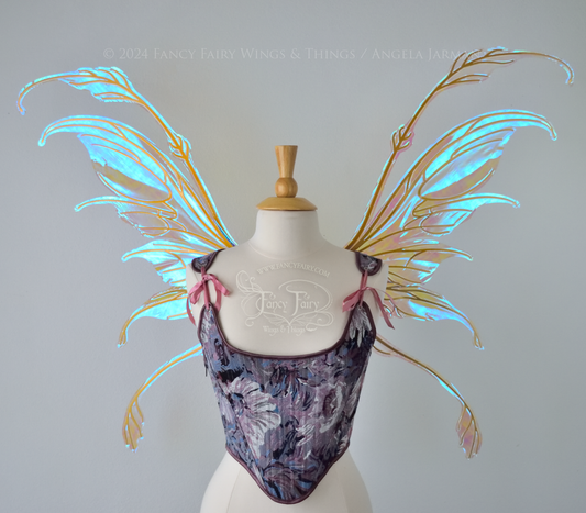 Large blue / green transparent iridescent fairy wings with downward curved tips, antennae & appendages, gold veins, worn on a dress form, front view