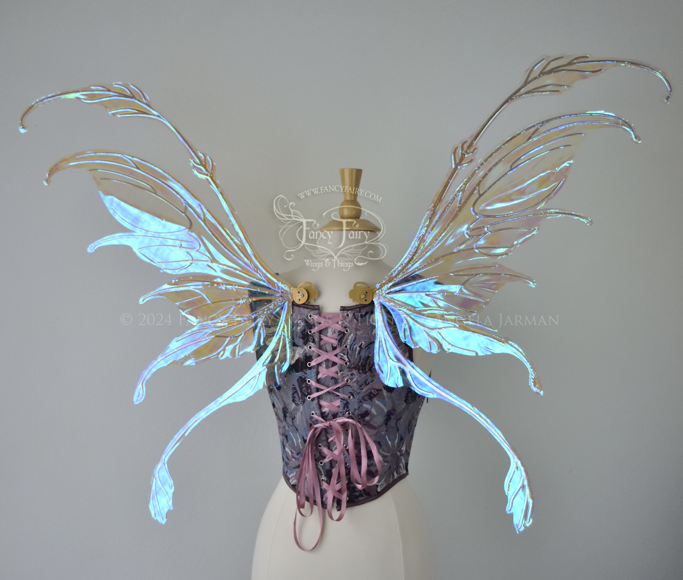 Large blue / green transparent iridescent fairy wings with downward curved tips, antennae & appendages, gold veins, worn on a dress form, back view