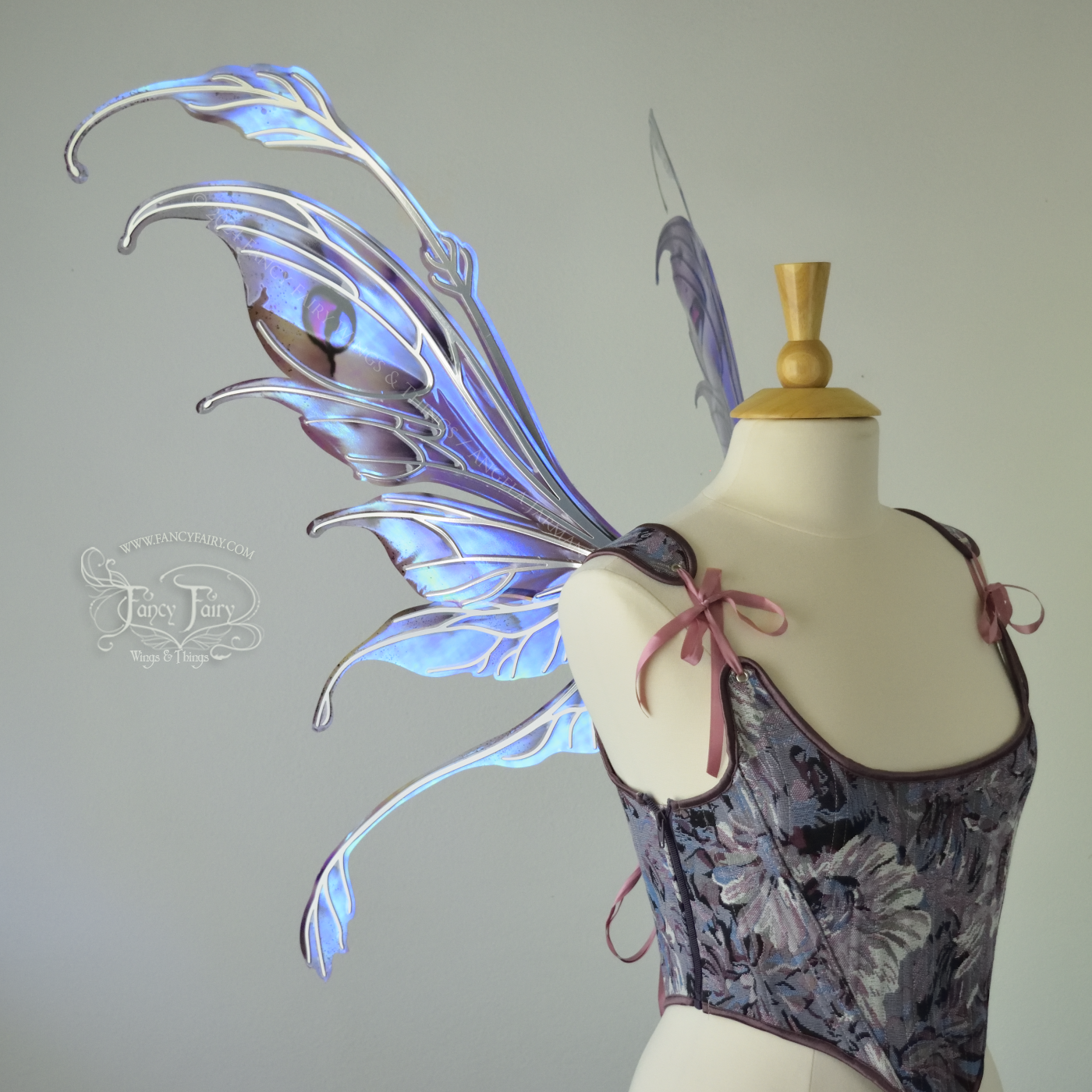 Iridescent fairy wings with antennae in purples, blues, and black with red accent and silver veins, left side view