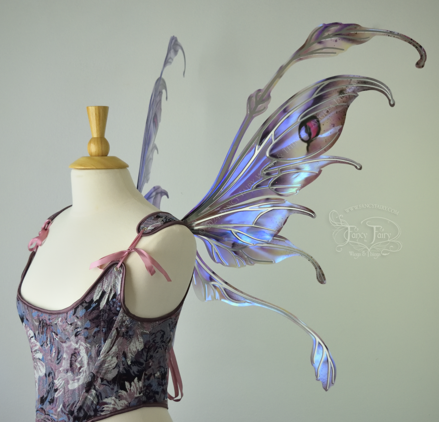 Iridescent fairy wings with antennae in purples, blues, and black with red accent and silver veins, right side view