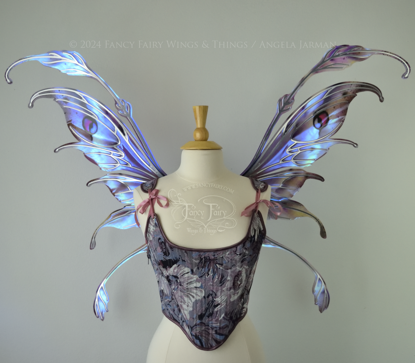 Iridescent fairy wings with antennae in purples, blues, and black with red accent and silver veins, front view