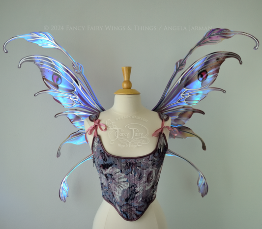 Iridescent fairy wings with antennae in purples, blues, and black with red accent and silver veins, front view