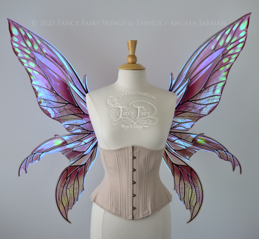 Front view of dress form wearing large plum iridescent fairy wings with green accents. 3 pointed panels each side, detailed black veins