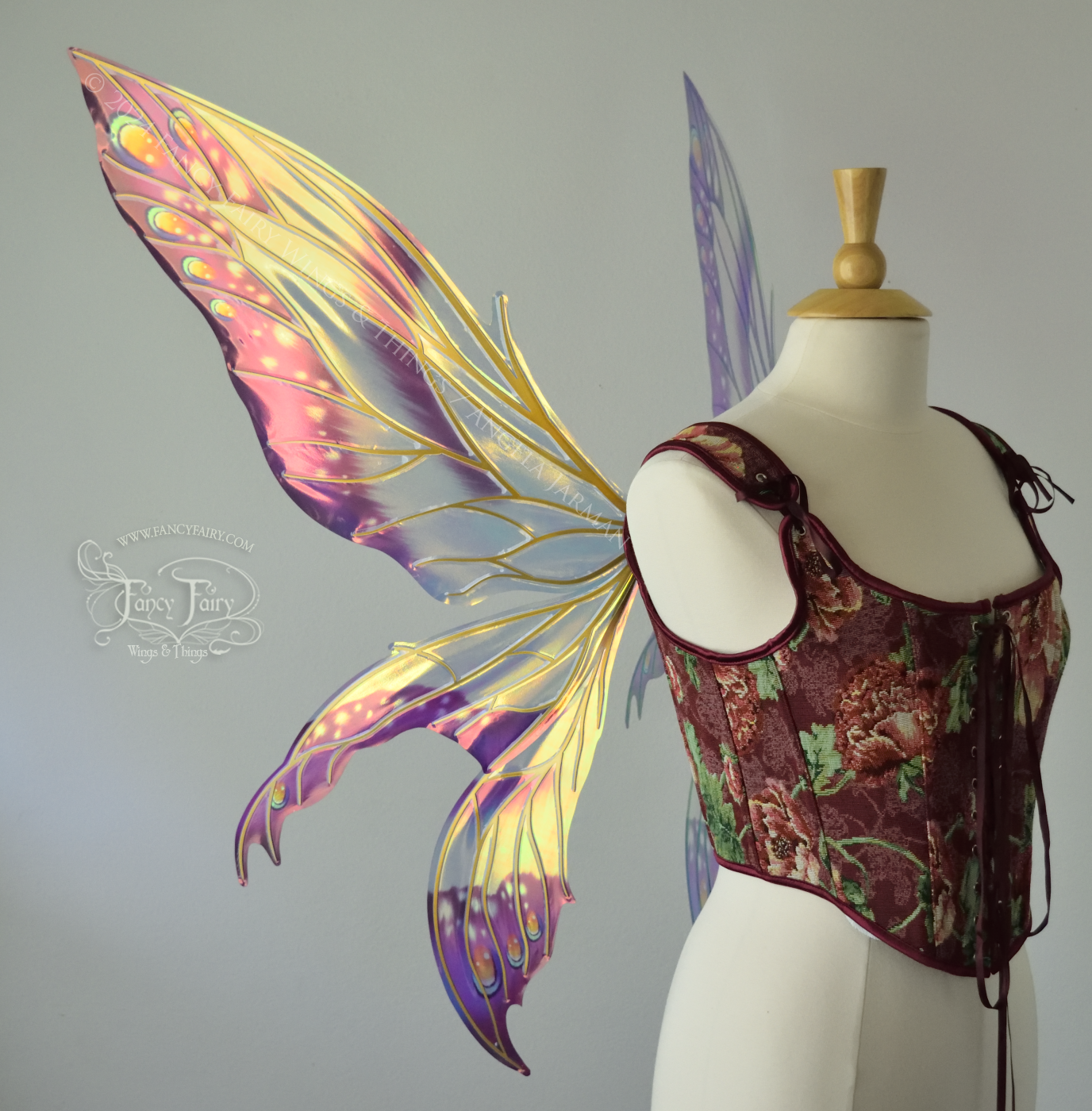 Large elongated iridescent fairy wings with burgundy, orange and blue accents & gold veins, 3 panels each side, worn on a dress form, left side view