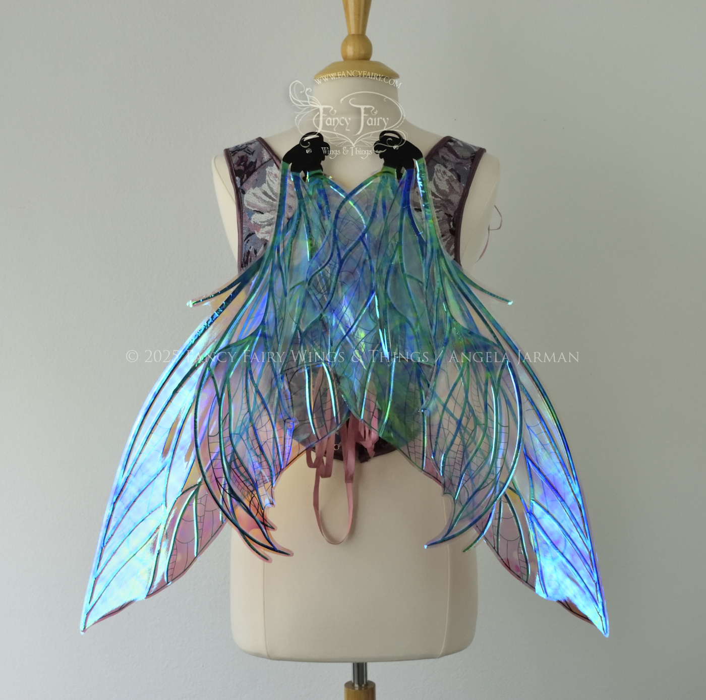 Large dragonfly-like transparent & iridescent blue & mauve fairy wings with black veins, 3 panels on each side, worn on dress form, back view, wings in resting position