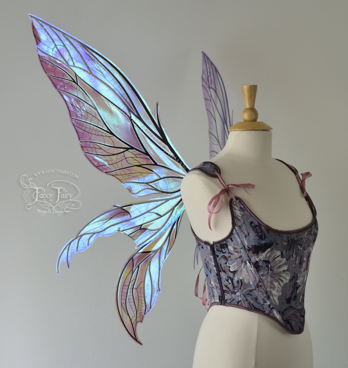 Large dragonfly-like transparent & iridescent blue & mauve fairy wings with black veins, 3 panels on each side, worn on dress form, left side view