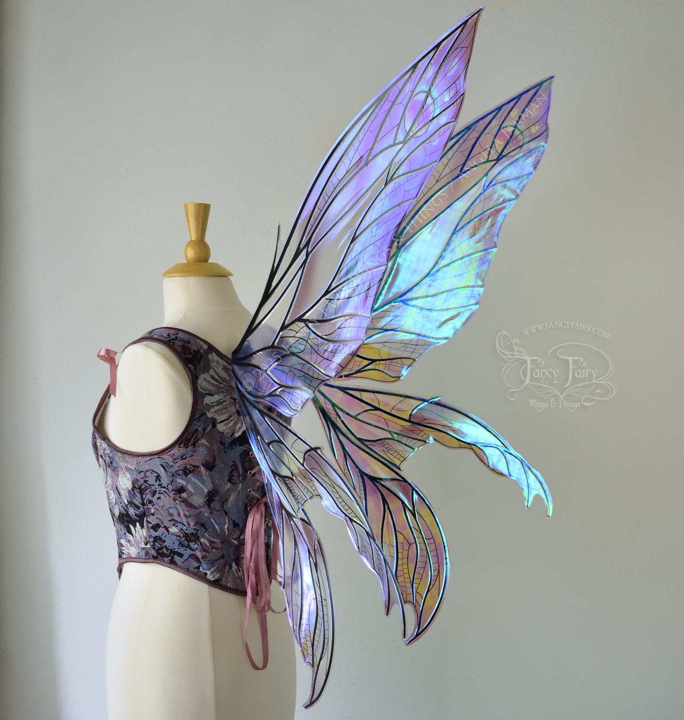 Large dragonfly-like transparent & iridescent blue & mauve fairy wings with black veins, 3 panels on each side, worn on dress form, back 3/4 view