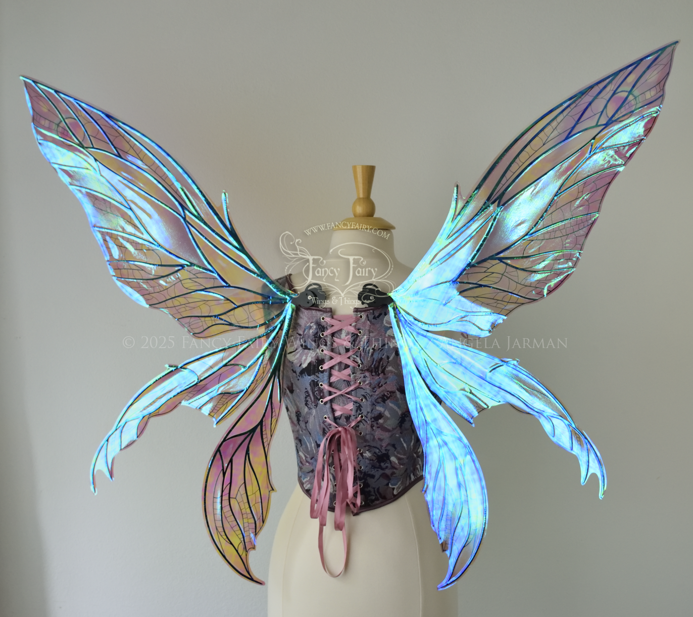 Large dragonfly-like transparent & iridescent blue & mauve fairy wings with black veins, 3 panels on each side, worn on dress form, back view