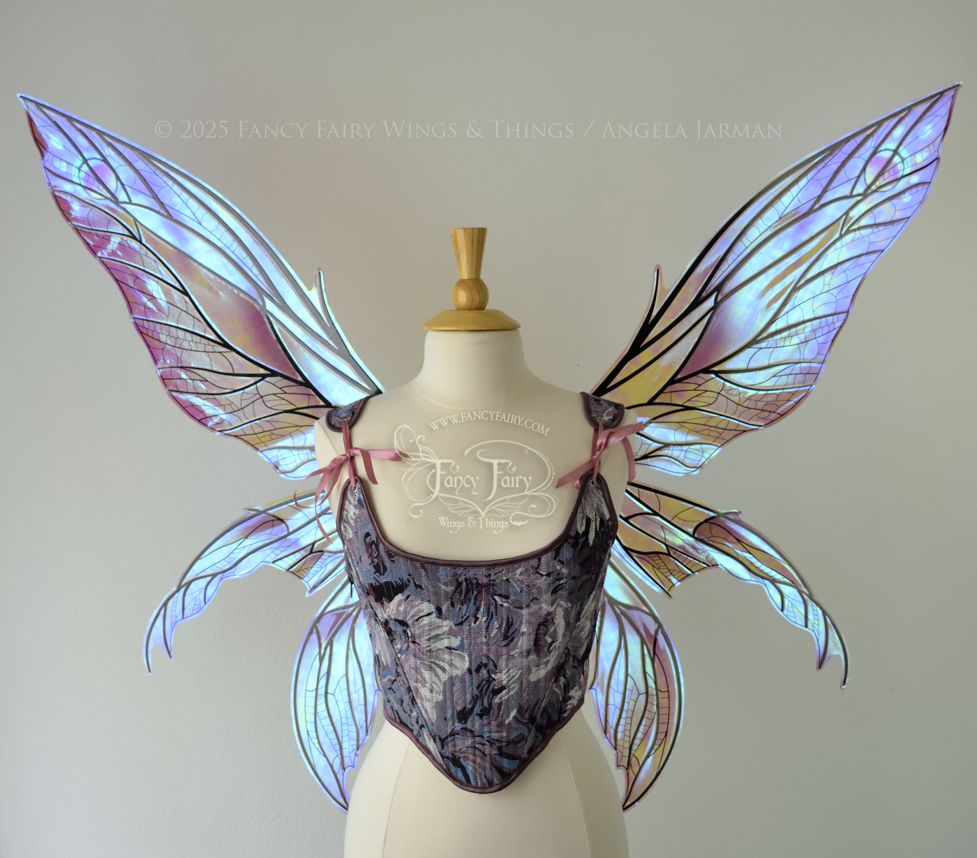 Large dragonfly-like transparent & iridescent blue & mauve fairy wings with black veins, 3 panels on each side, worn on dress form, front view