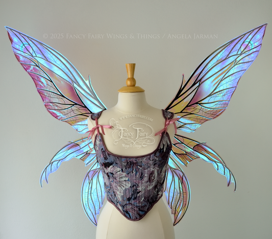 Large dragonfly-like transparent & iridescent blue & mauve fairy wings with black veins, 3 panels on each side, worn on dress form, front view