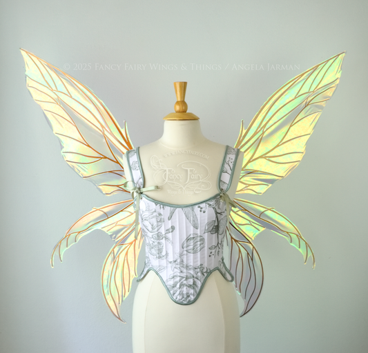 Large transparent iridescent orange/yellow/green dragonfly-like iridescent fairy wings with copper veins have 3 elongated panels on each side, worn on a dress form, front view