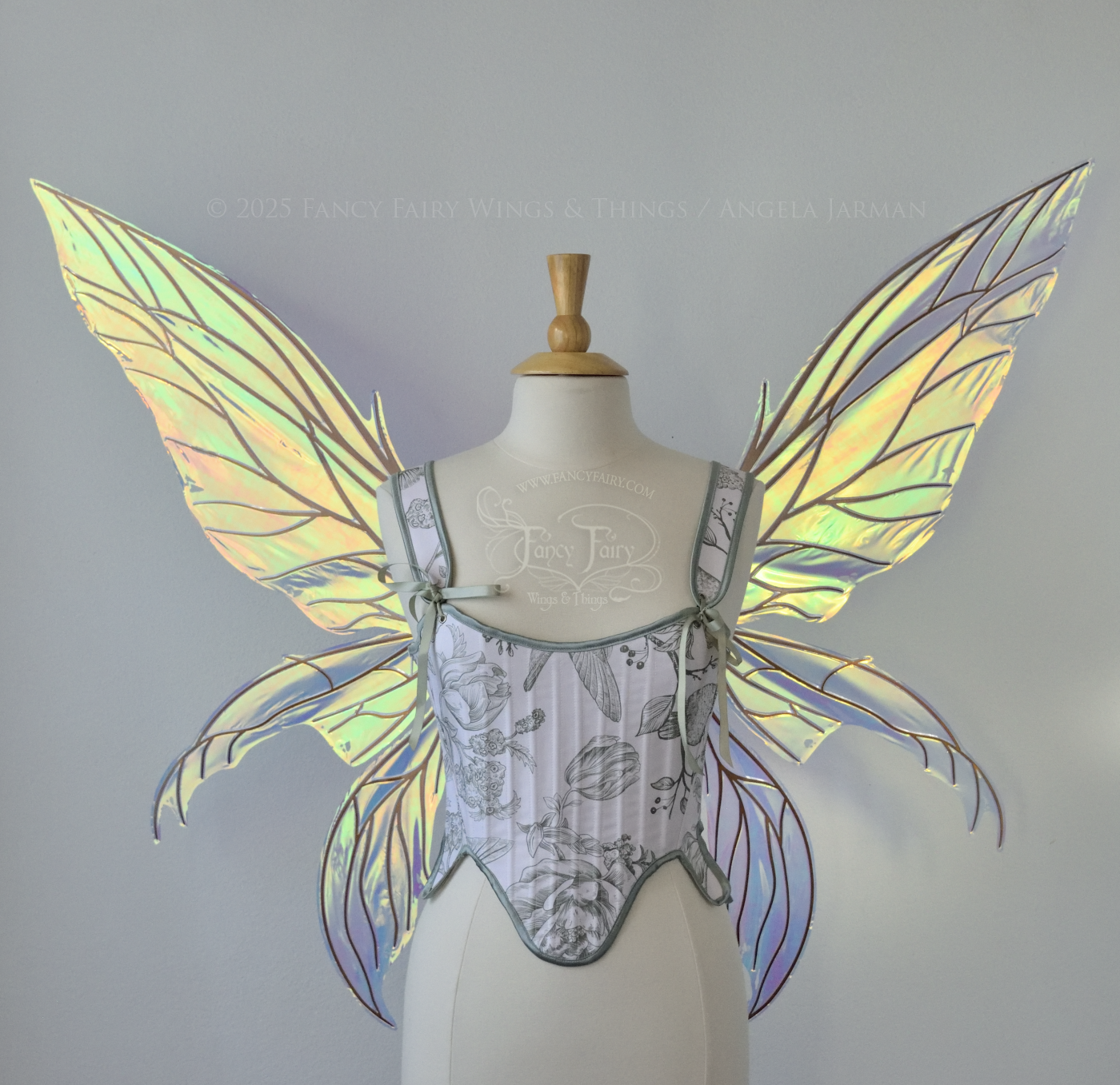 Large transparent iridescent orange/yellow/green dragonfly-like iridescent fairy wings with copper veins have 3 elongated panels on each side, worn on a dress form, front view