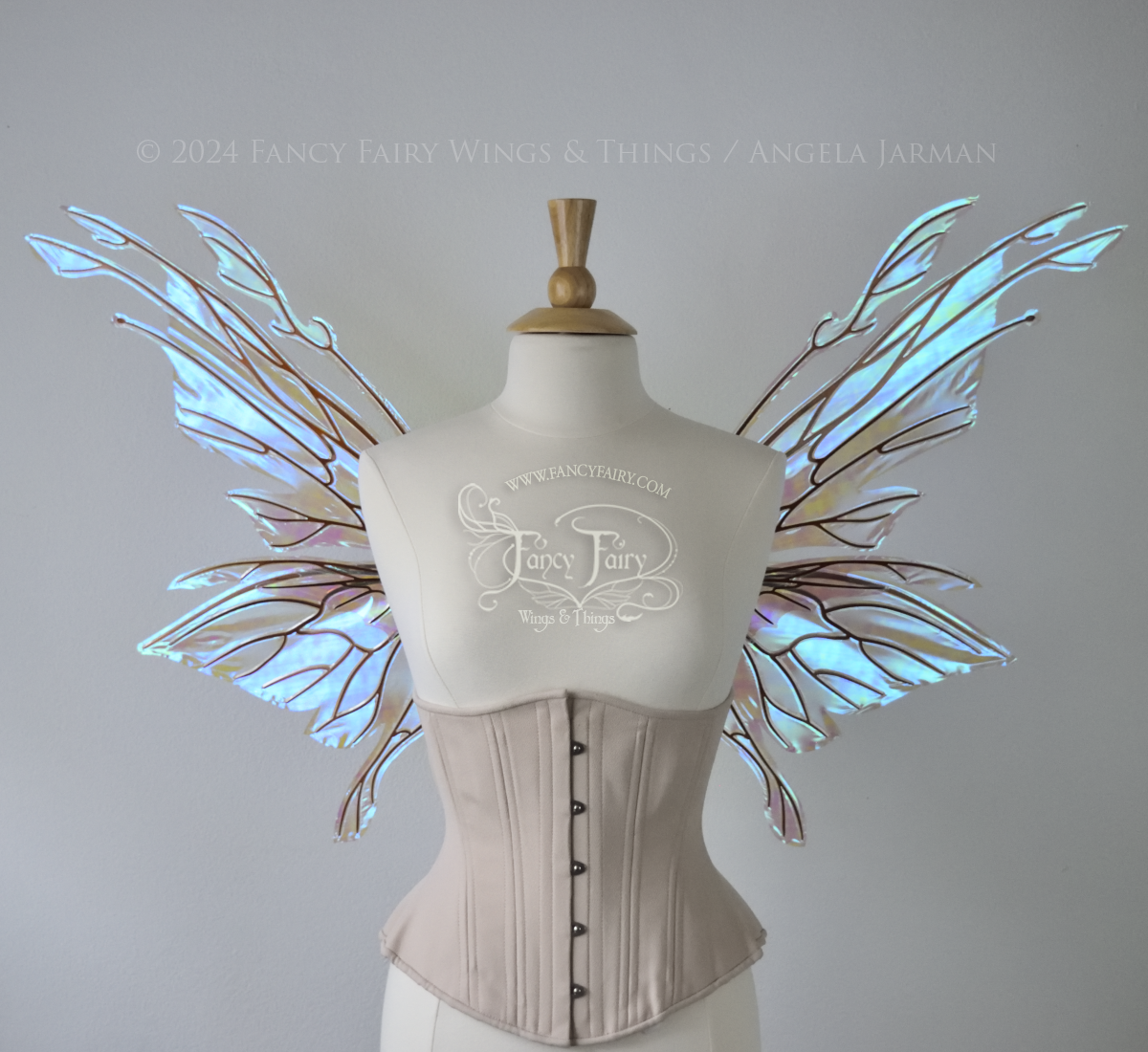 Large blue green iridescent fairy wings with copper veins worn with an alabaster corset on a dress form