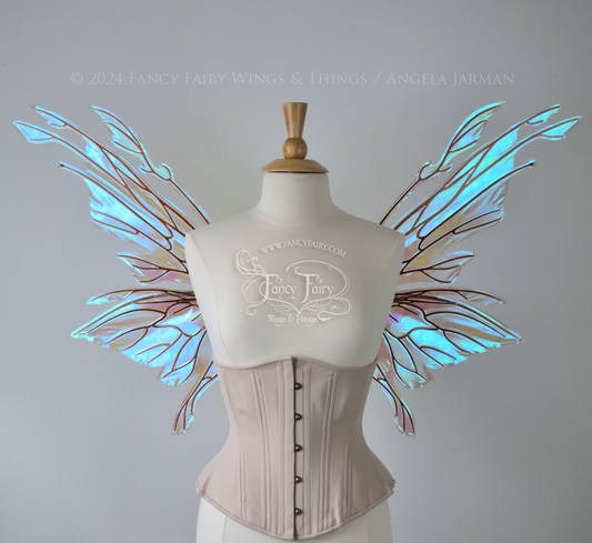 Large blue green iridescent fairy wings with copper veins worn with an alabaster corset on a dress form