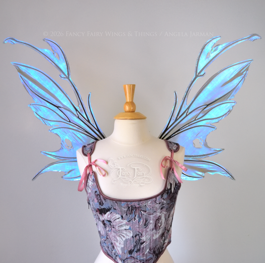 Iridescent & transparent purple & blue fairy wings with black veins and antennae, worn on a dress form, front view