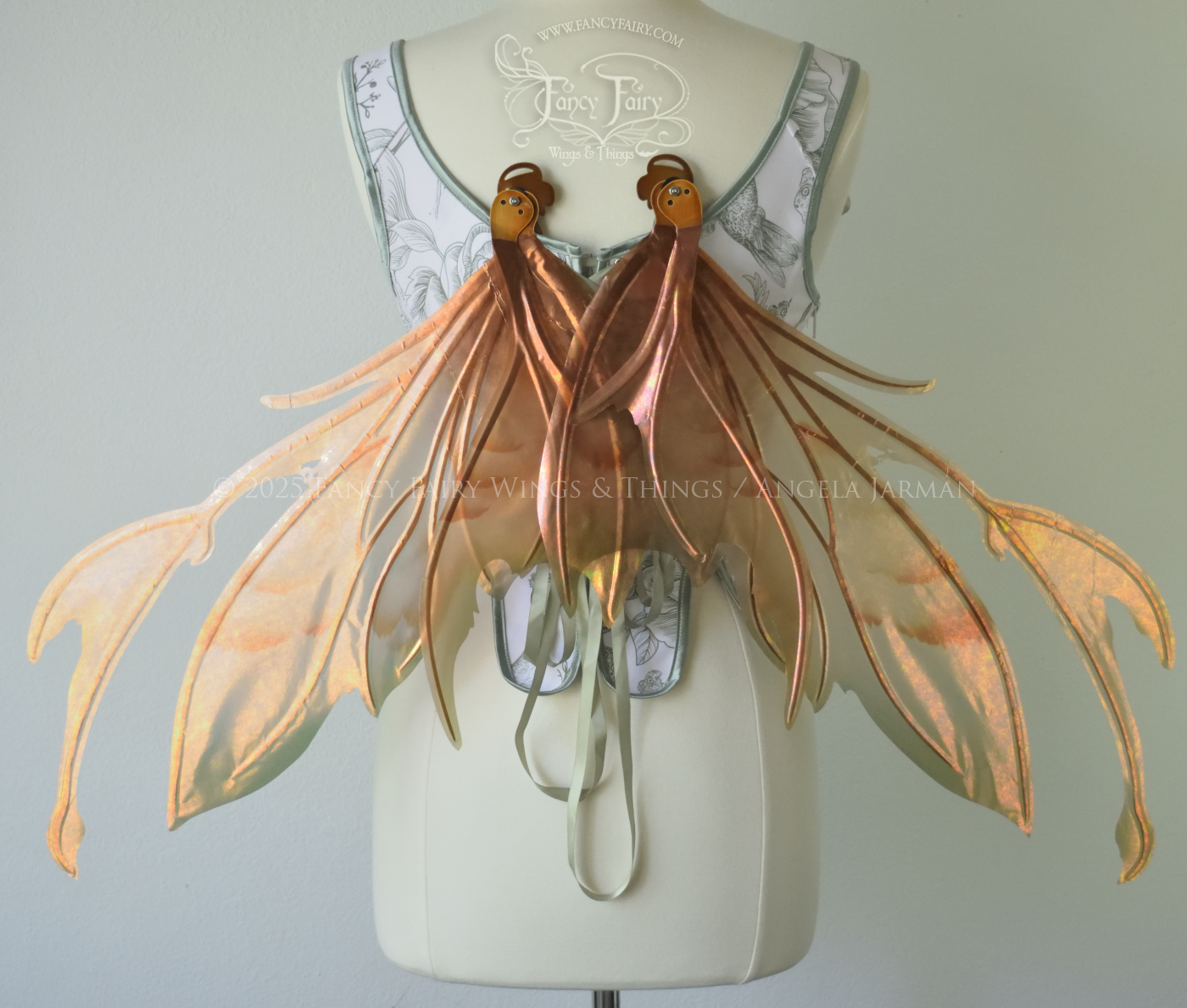 Rose Gold iridescent fairy wings with antennae and brown & olive green accents, copper veins, worn on a dress form, back view, resting position