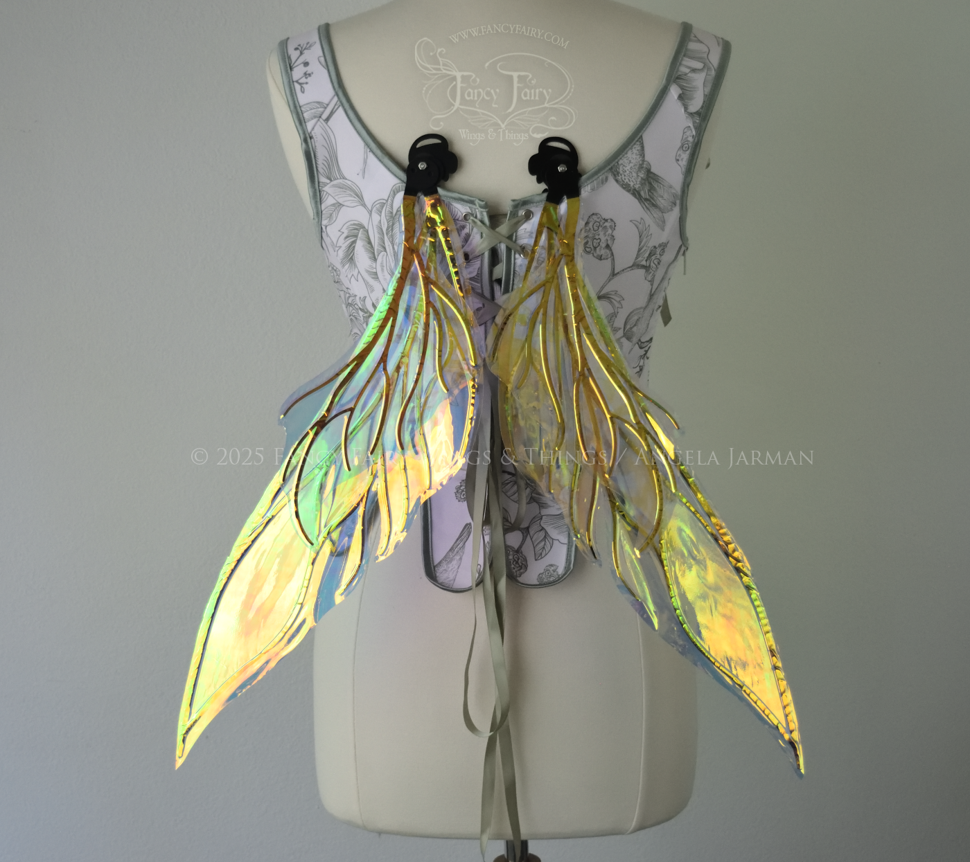 Iridescent green / orange / yellow fairy wings with elongated pointy upper panels and small leaf like lower panels, with black veins, back view, in resting position