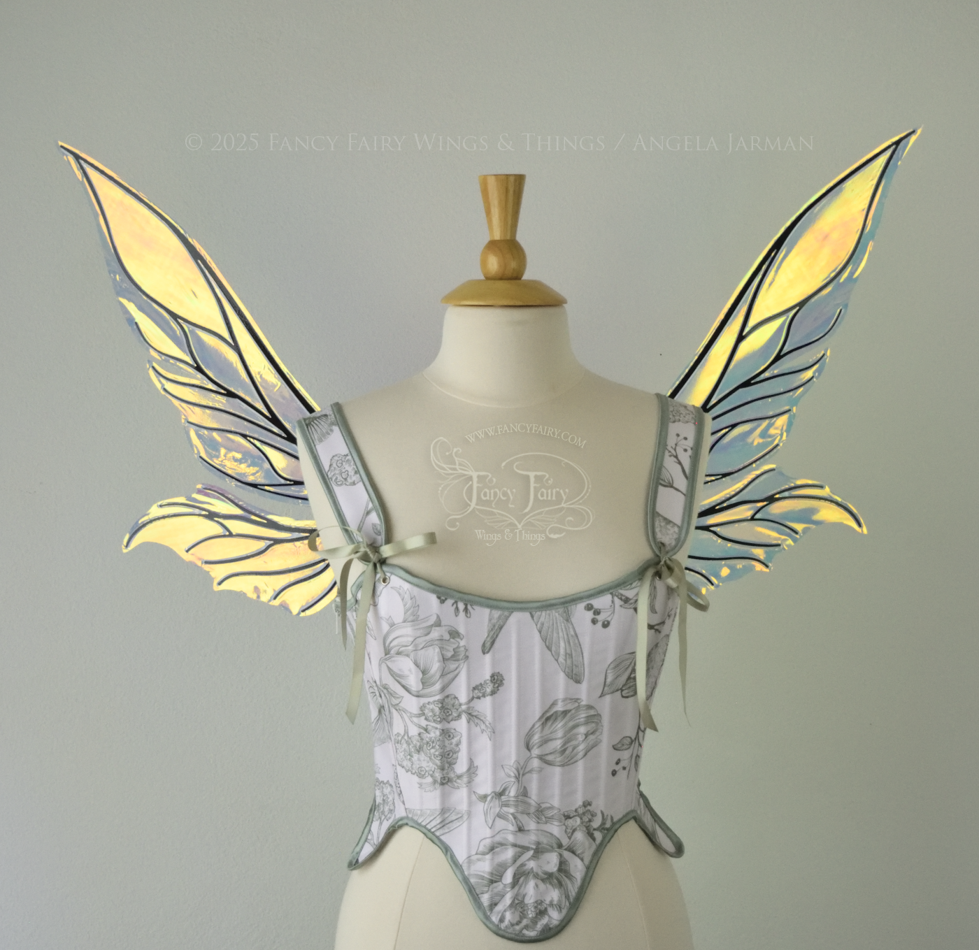 Iridescent green / orange / yellow fairy wings with elongated pointy upper panels and small leaf like lower panels, with black veins, front view