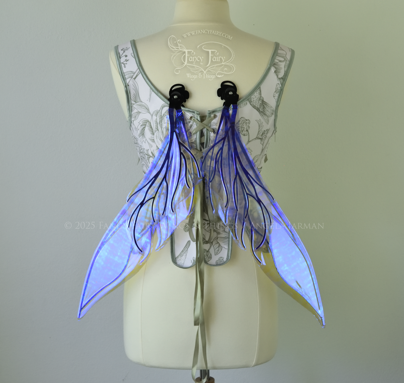 Iridescent & transparent violet fairy wings with elongated pointy upper panels and small leaf like lower panels, with black veins, back view, in resting position