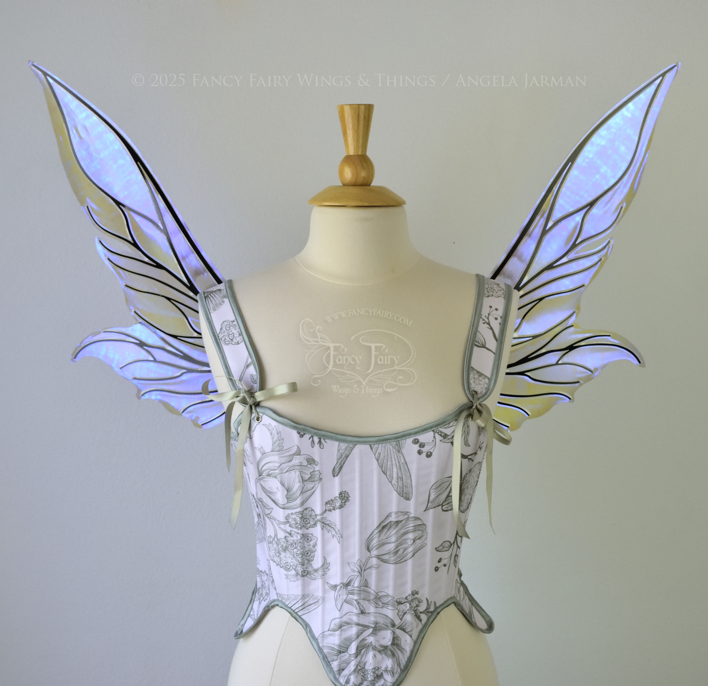 Iridescent & transparent violet fairy wings with elongated pointy upper panels and small leaf like lower panels, with black veins, front view