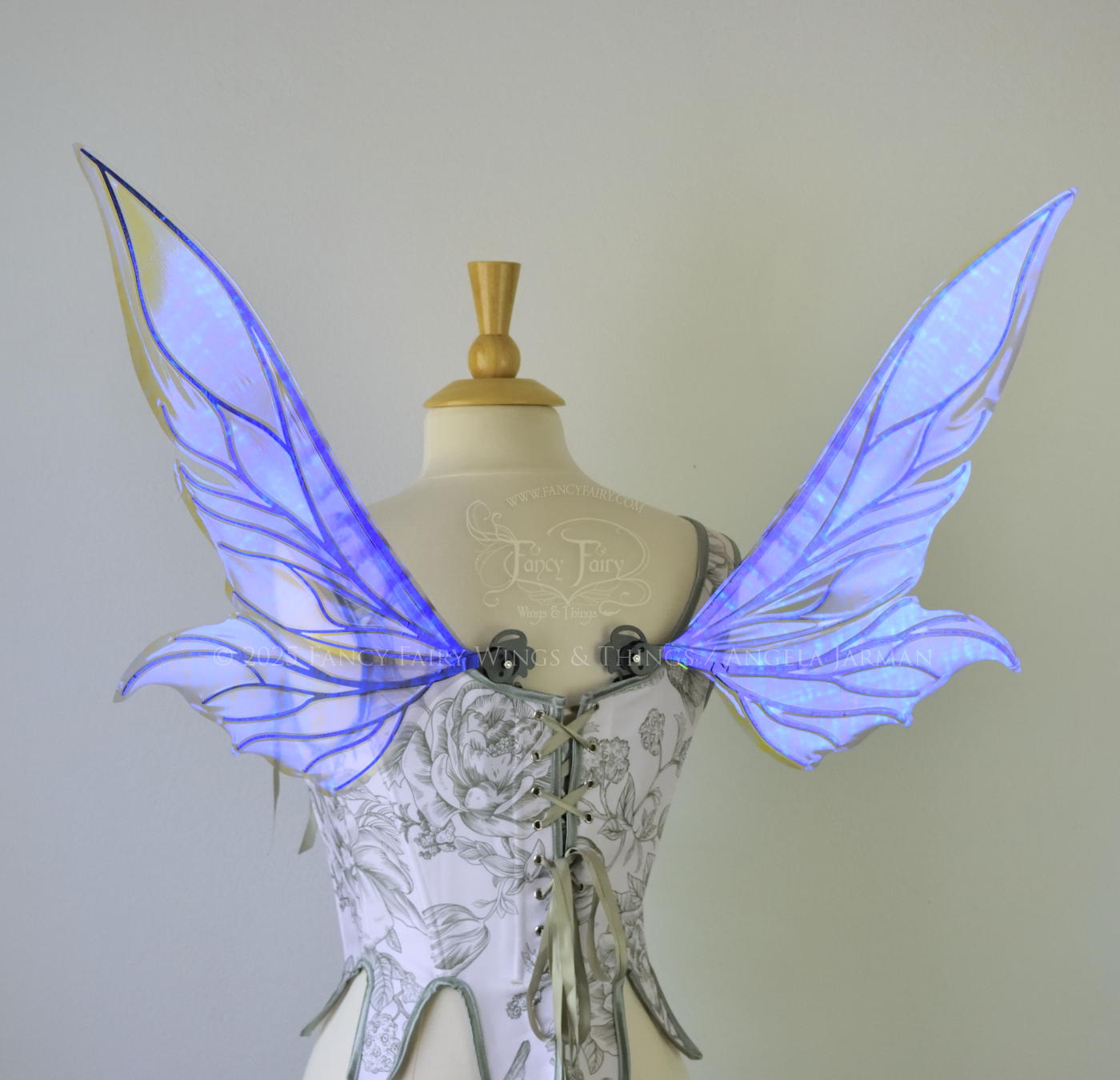 Iridescent & transparent violet fairy wings with elongated pointy upper panels and small leaf like lower panels, with black veins, back view