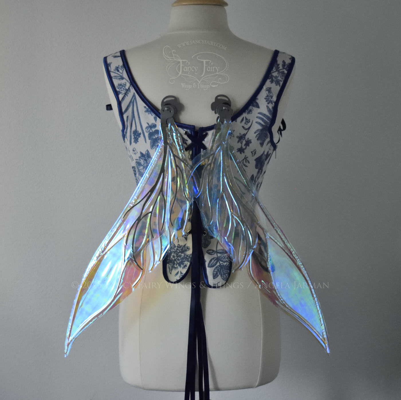 Iridescent & transparent elongated blue fairy wings with silver veins, back view , in resting position, worn on dress form