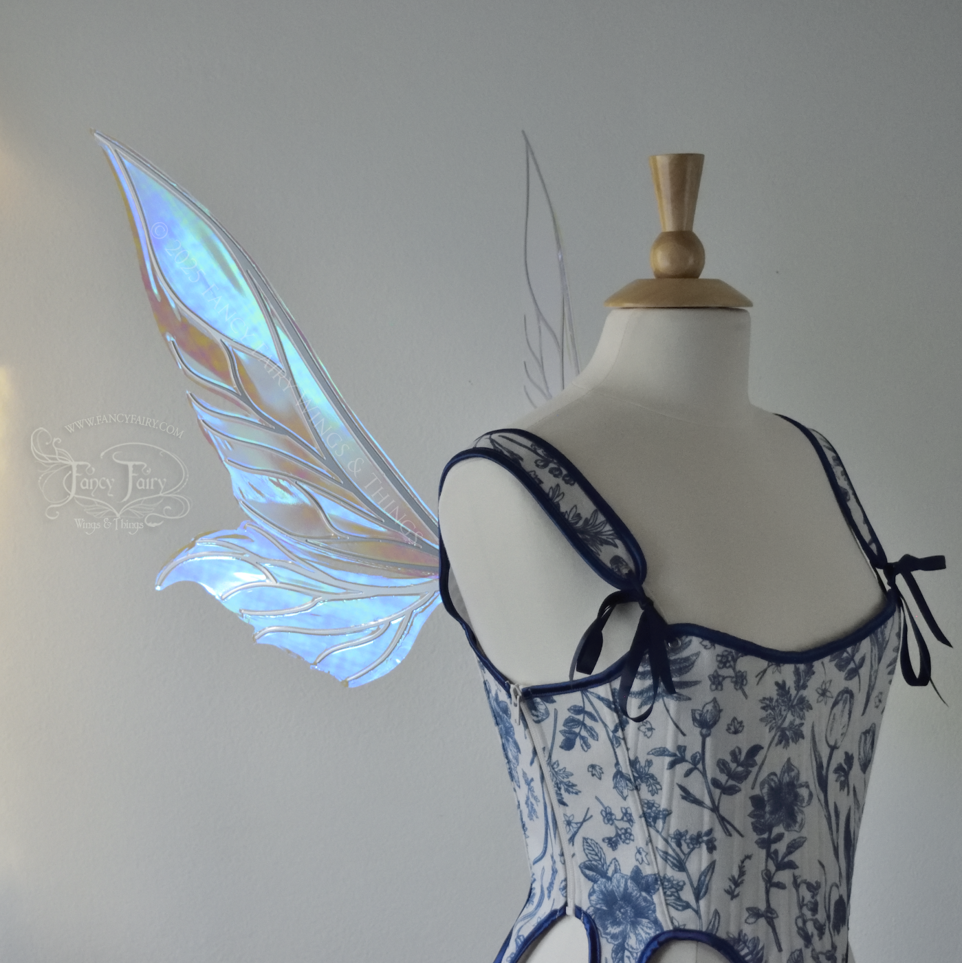 Iridescent & transparent elongated blue fairy wings with silver veins, left side view, worn on dress form