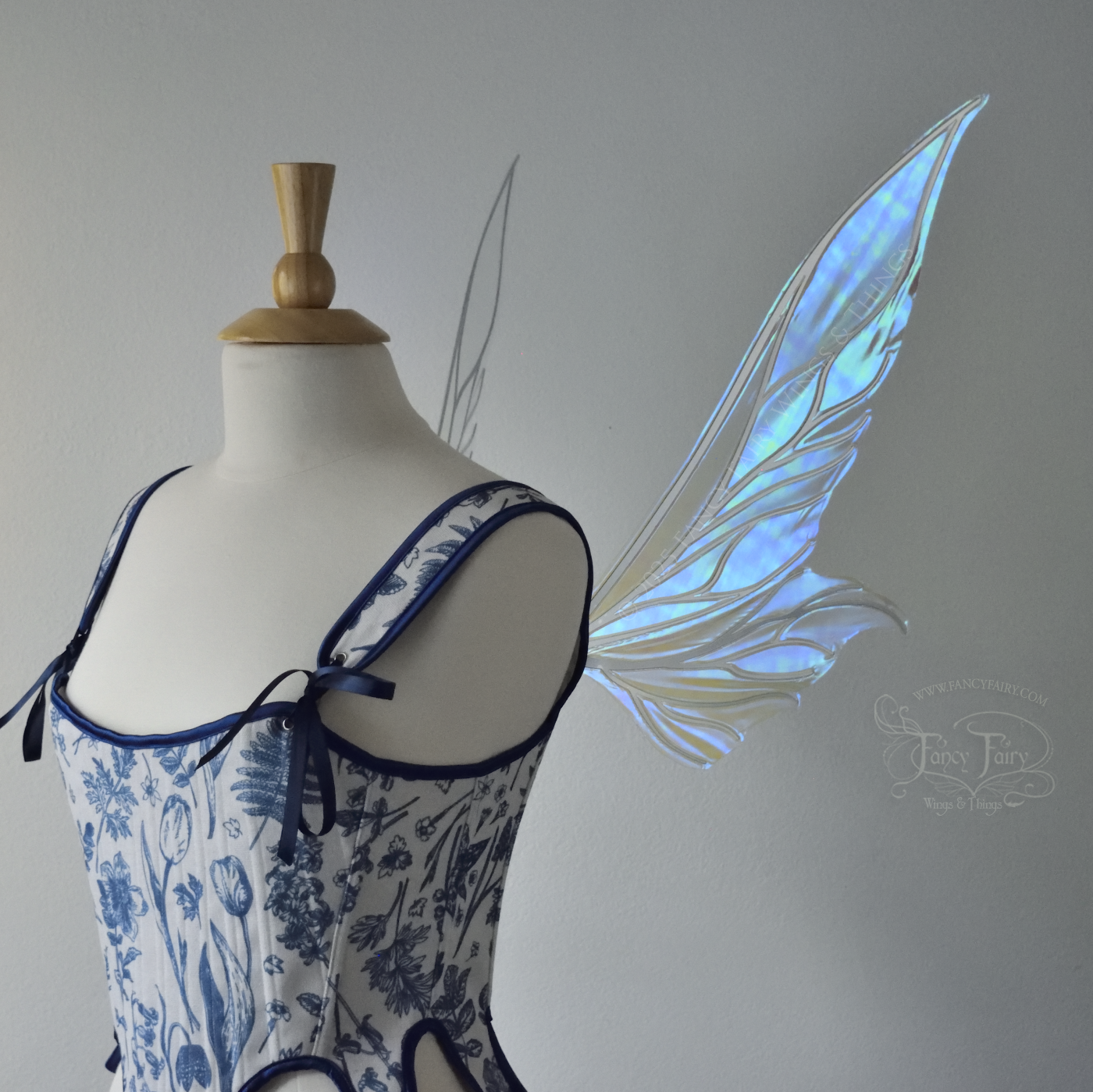 Iridescent & transparent elongated blue fairy wings with silver veins, right side view, worn on dress form