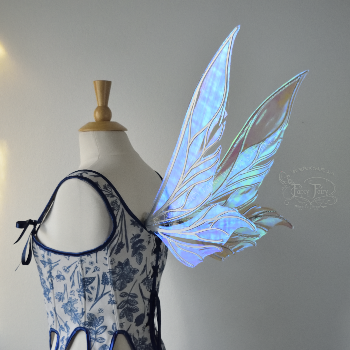 Iridescent & transparent elongated blue fairy wings with silver veins, back 3/4 view, worn on dress form