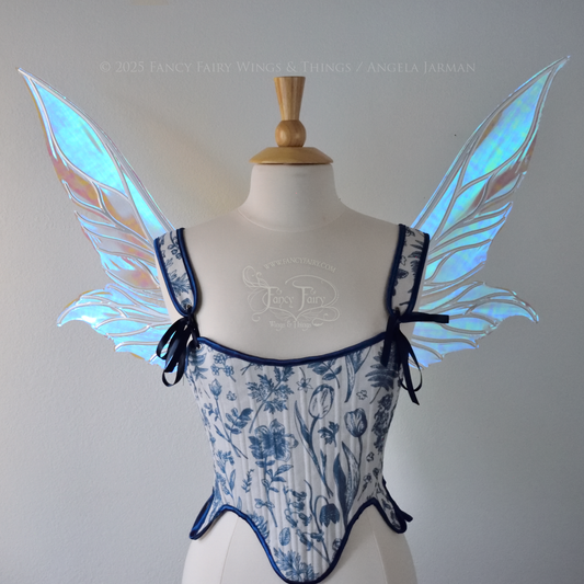 Iridescent & transparent elongated blue fairy wings with silver veins, front view, worn on dress form