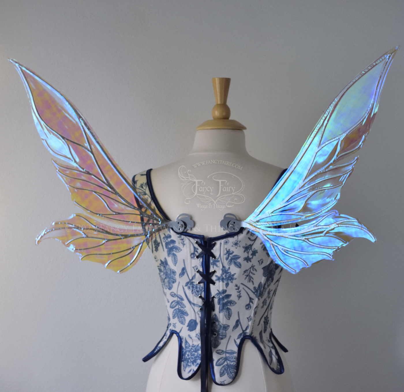 Iridescent & transparent elongated blue fairy wings with silver veins, back view, worn on dress form